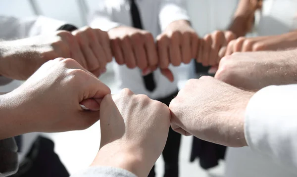 close up. business team forming a circle, out of their fists