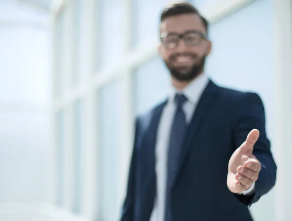 Successful businessman holding out his hand for a handshake — Stock Photo, Image