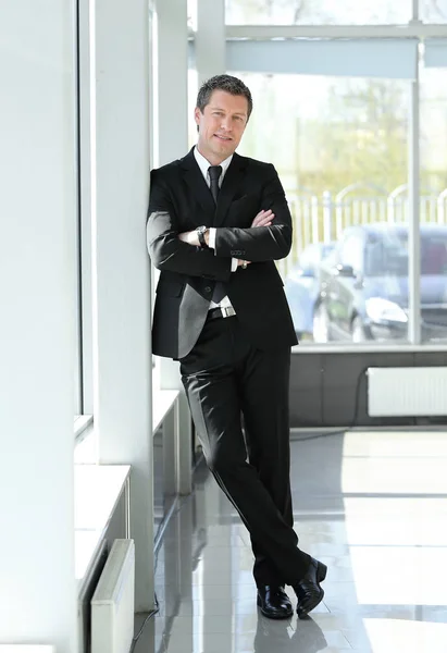 Homem de negócios sério em pé no corredor do escritório . — Fotografia de Stock
