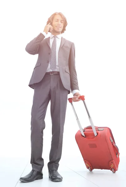 Uomo d'affari con valigia da viaggio che parla sul cellulare — Foto Stock