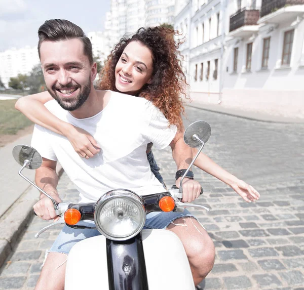 Happy cheerful couple riding vintage scooter outdoors. — Stock Photo, Image