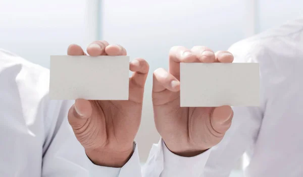 Close up. Two businessmen showing their business cards — стоковое фото