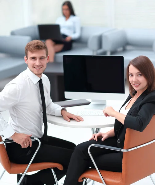 Lächelndes Mitglied des Geschäftsteams am Schreibtisch — Stockfoto