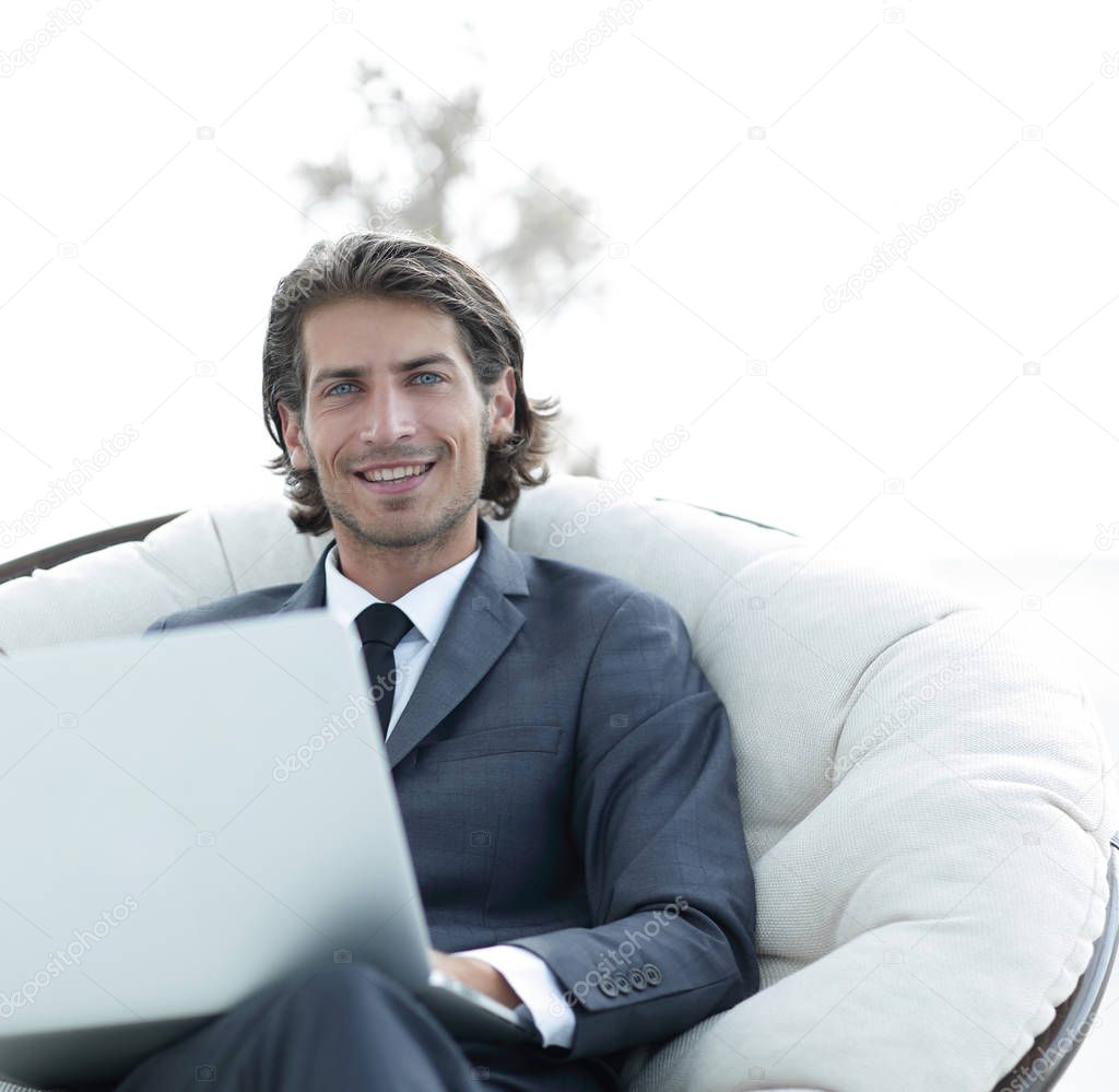 Close-up portrait of a successful business man with a laptop.