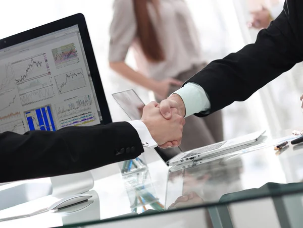 businessman welcomes business partner shaking hands