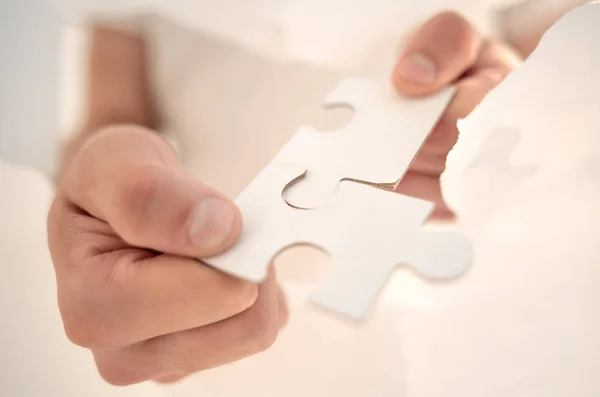 Close up.businessman connects the pieces of the puzzle — Stock Photo, Image