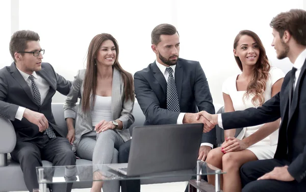 Business partners shaking hands during negotiations — Stock Photo, Image