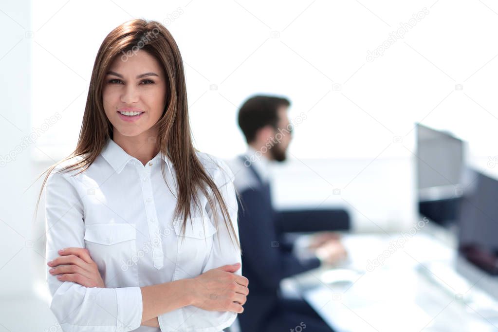 smiling business woman on the background of the workplace.