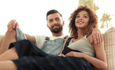 Genç çift kanepede oturan iş elbiseleri