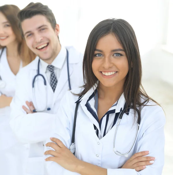 Female doctor with group of happy successful colleagues — Stock Photo, Image