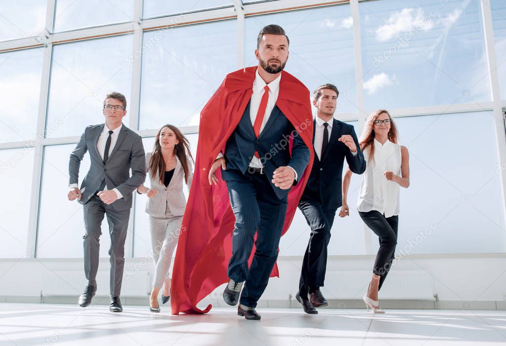 business team and their leader are marching in the office lobby