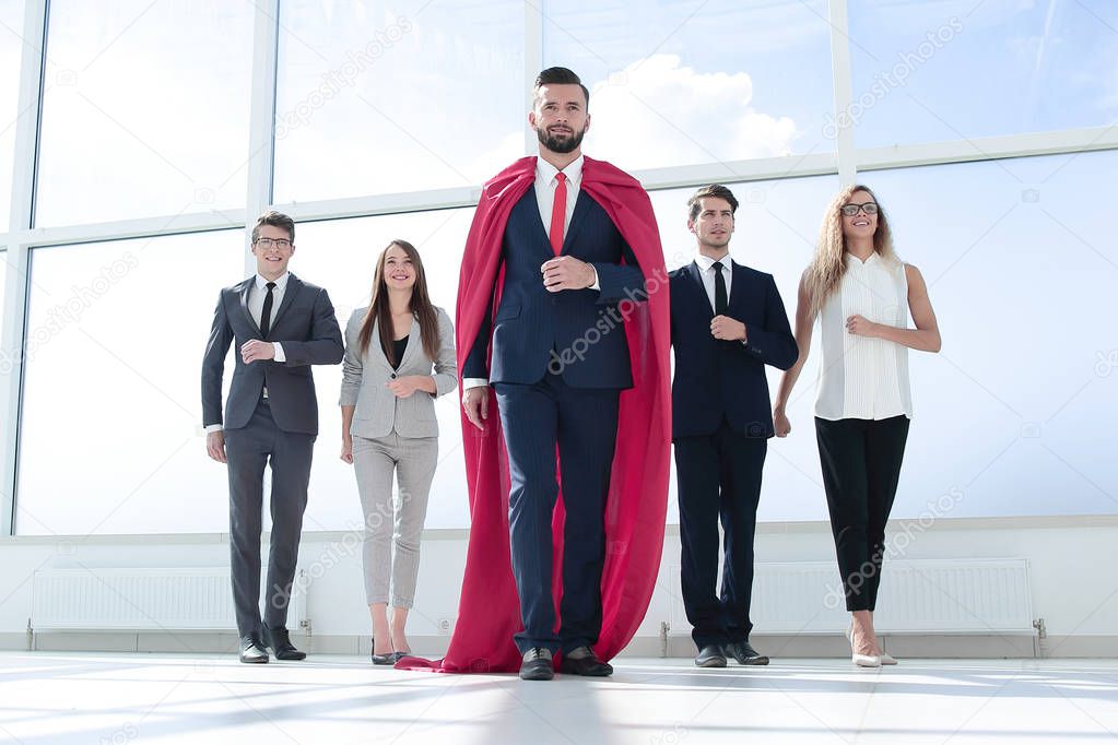 businessman-superhero and business team standing in the office.photo with copy space