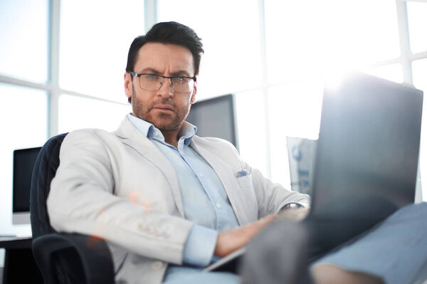 close up.a successful man with a laptop.