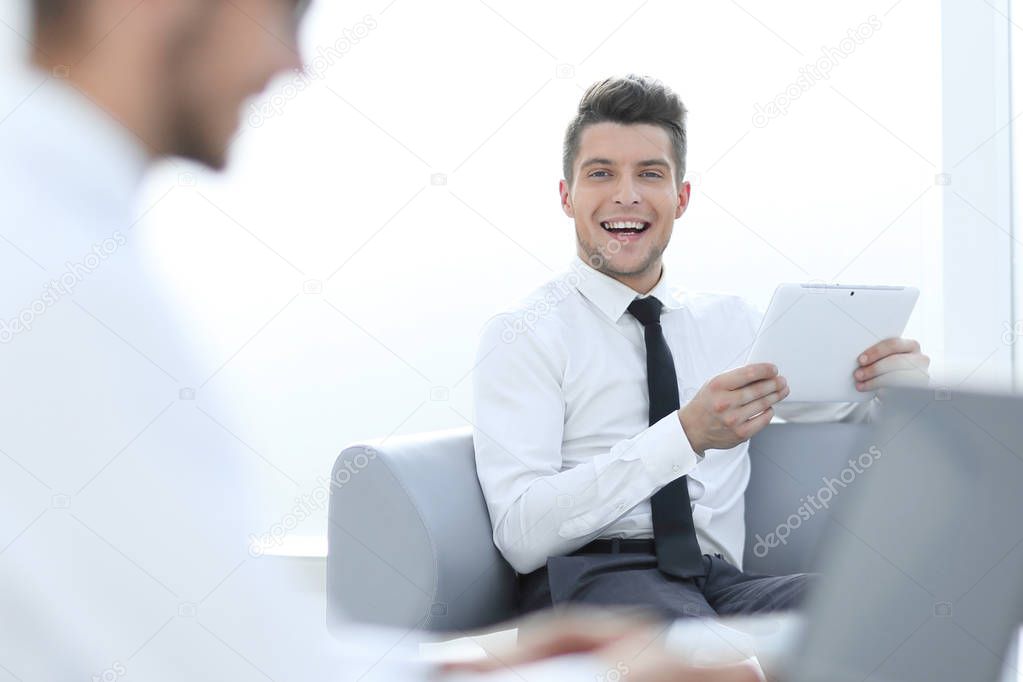 Young businessman in formalwear typing on laptop