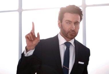 close up. serious businessman showing gesture of attention clipart