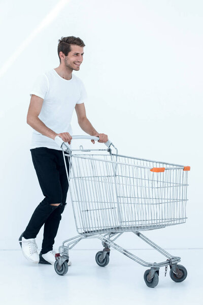 smiling man pushing shopping cart.