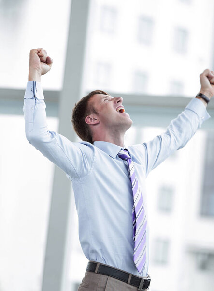 Businessman celebrating with his fists raised in the air