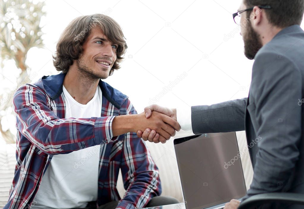 manager shakes hands with his client