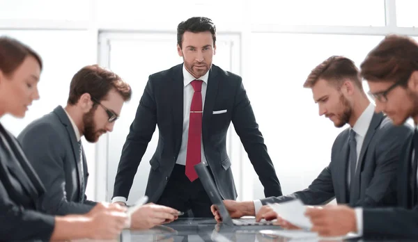 strict businessman at a working meeting with the business team.