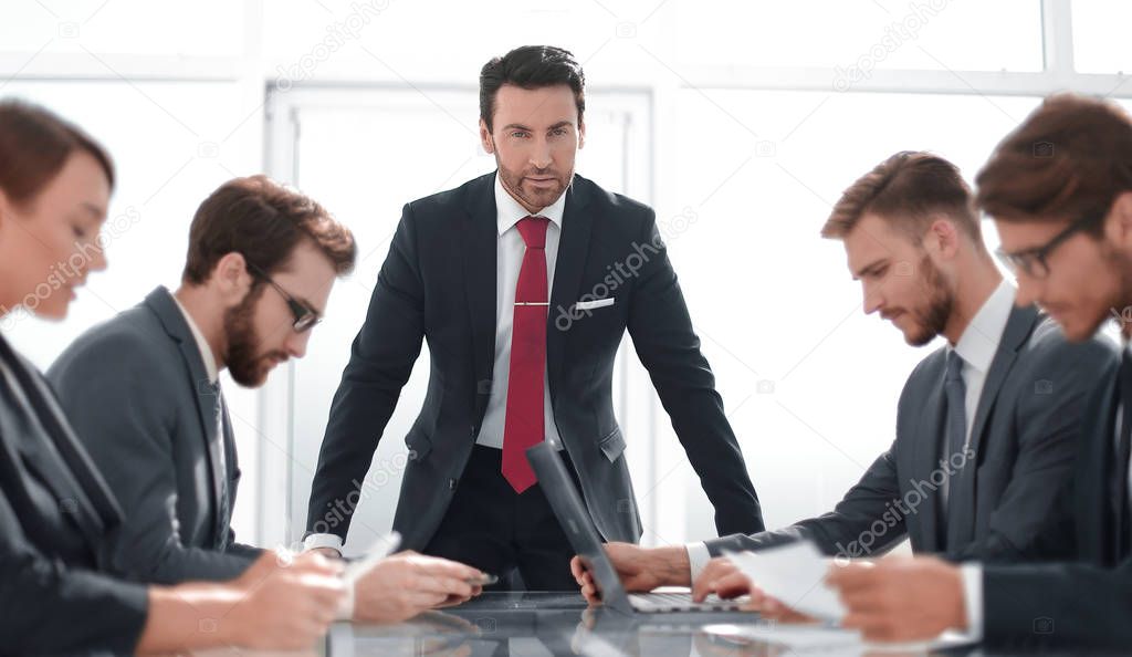 strict businessman at a working meeting with the business team.