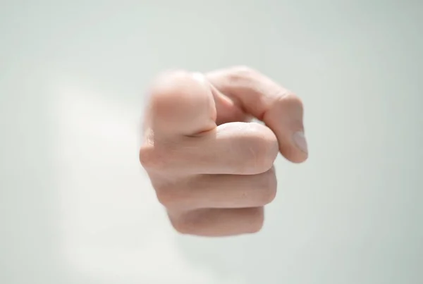 Close up.a mans hand breaking through the paper and pointing so — Stock Photo, Image