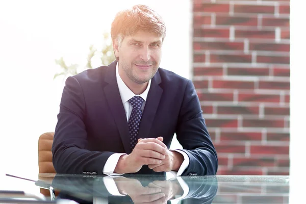 Homme d'affaires sérieux assis sur le bureau — Photo