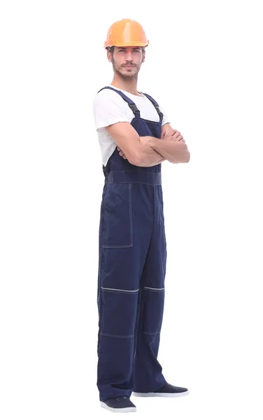 In full growth. confident man wearing overalls and a crash helmet. — Stock Photo, Image