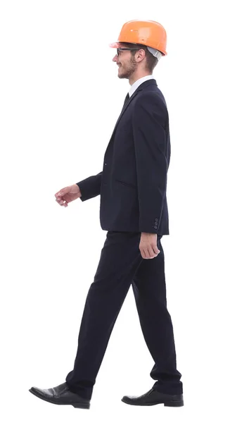 Businessman in a protective helmet, stepping forward — Stock Photo, Image