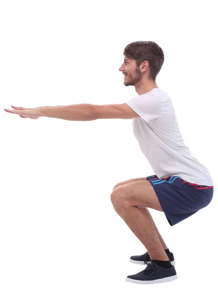 Full length.active maschio esegue squat con braccia dritte . — Foto Stock