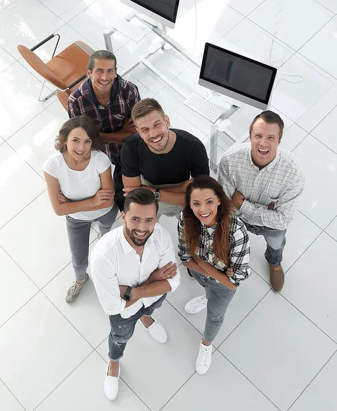 Young professionals standing near the desktop — Stock Photo, Image