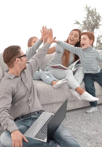 cheerful family spends their leisure time in their living room