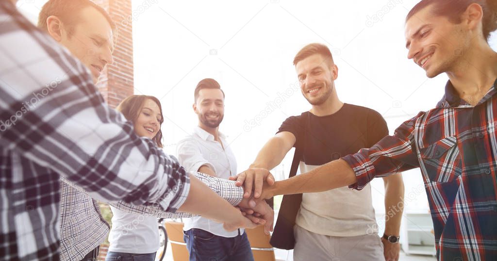 business team with hands clasped together