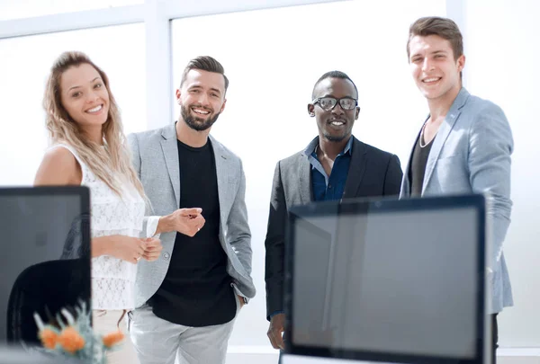 Usmívající se obchodní tým stojí v kanceláři — Stock fotografie