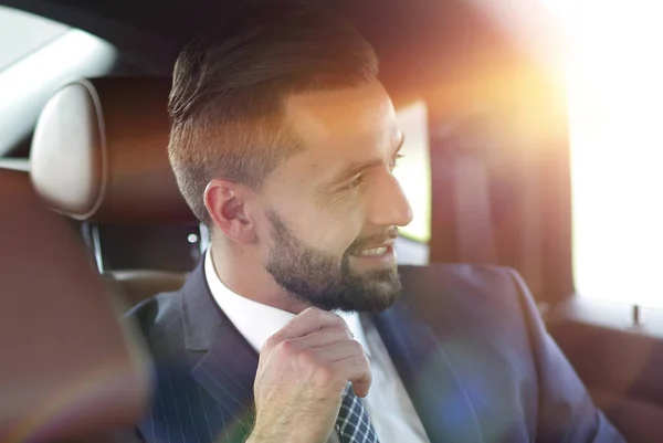 Close-up of a successful businessman sitting in a comfortable car — Stock Photo, Image