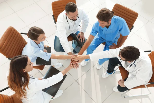 Medical staff hands clasped together,sitting at a Desk — Stock Photo, Image