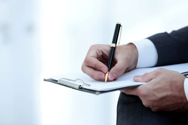Businessman signs a contract. Holding pen in hand. — Stock Photo, Image