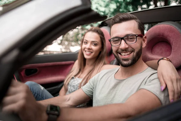 Close up.stylish man with his girlfriend traveling in a converti — Stock Photo, Image