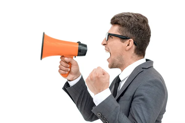 Close up. angry businessman shouting into megaphone — Stock Photo, Image