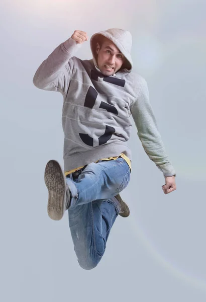 Funny cheerful happy man jumping in air over gray background — Stock Photo, Image