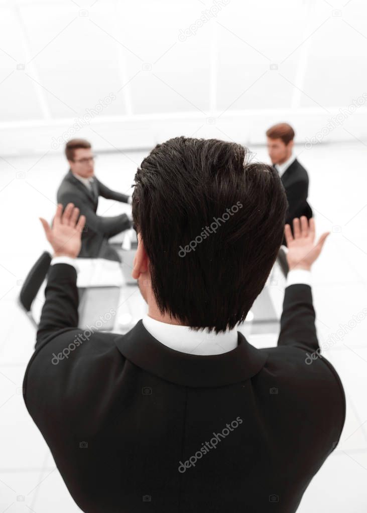 rear view.businessman refers to colleagues in the conference room