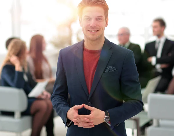 Successful businessman on blurred background business team. — Stock Photo, Image