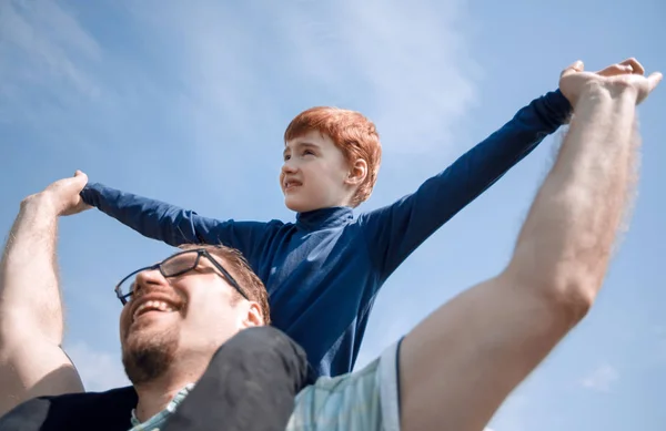 Happy father has a little son on his shoulders — Stock Photo, Image