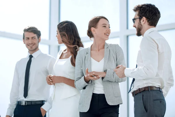 Young employees talk in the office — Stock Photo, Image