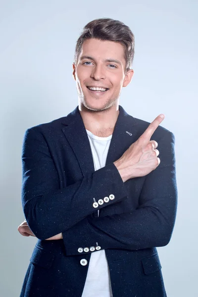 Attractive young man in suit pointing up with his finger isolate — Stock Photo, Image