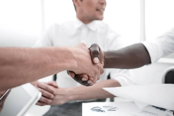 Close up.handshake parceiros de negócios sentados na mesa — Fotografia de Stock