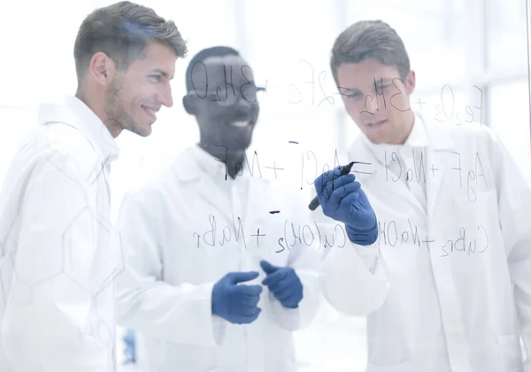 Promising scientist makes notes on the Board — Stock Photo, Image