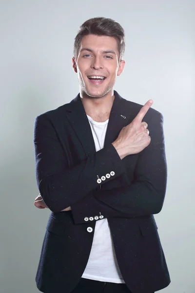 Attractive young man in suit pointing up with his finger isolate