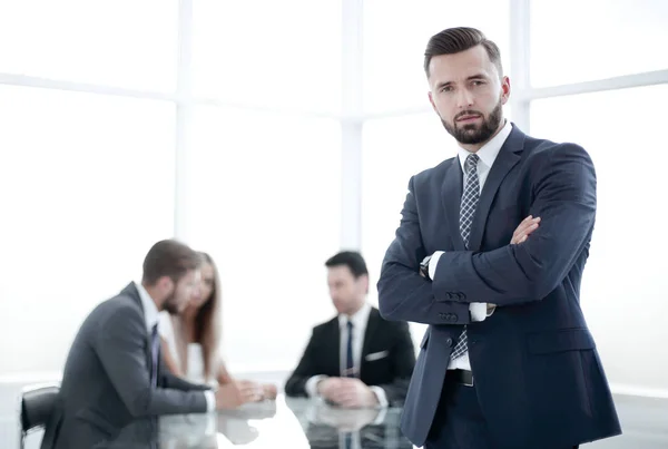 Modern businessman standing in a bright office — Stock Photo, Image