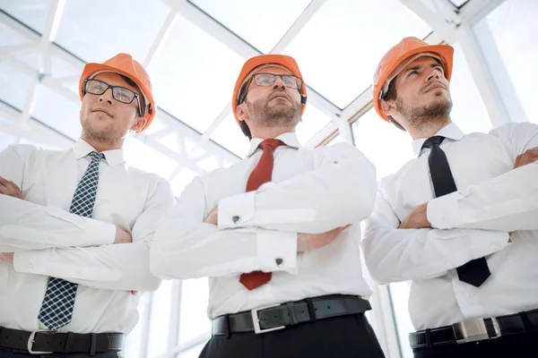 Close up.a group of architects and designers in protective helmets — Stock Photo, Image