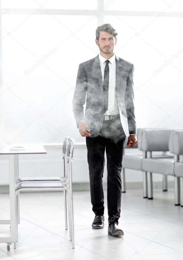 full-length businessman in a smoky office